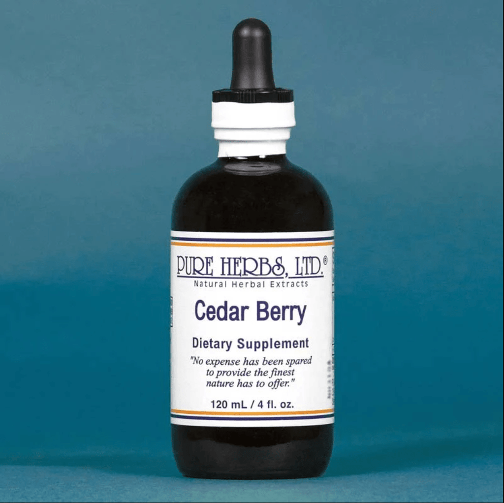 A 120 mL amber glass dropper bottle of Pure Herbs, Ltd. Cedar Berry dietary supplement, featuring a white label with blue text and a black rubber dropper cap, set against a solid blue background.