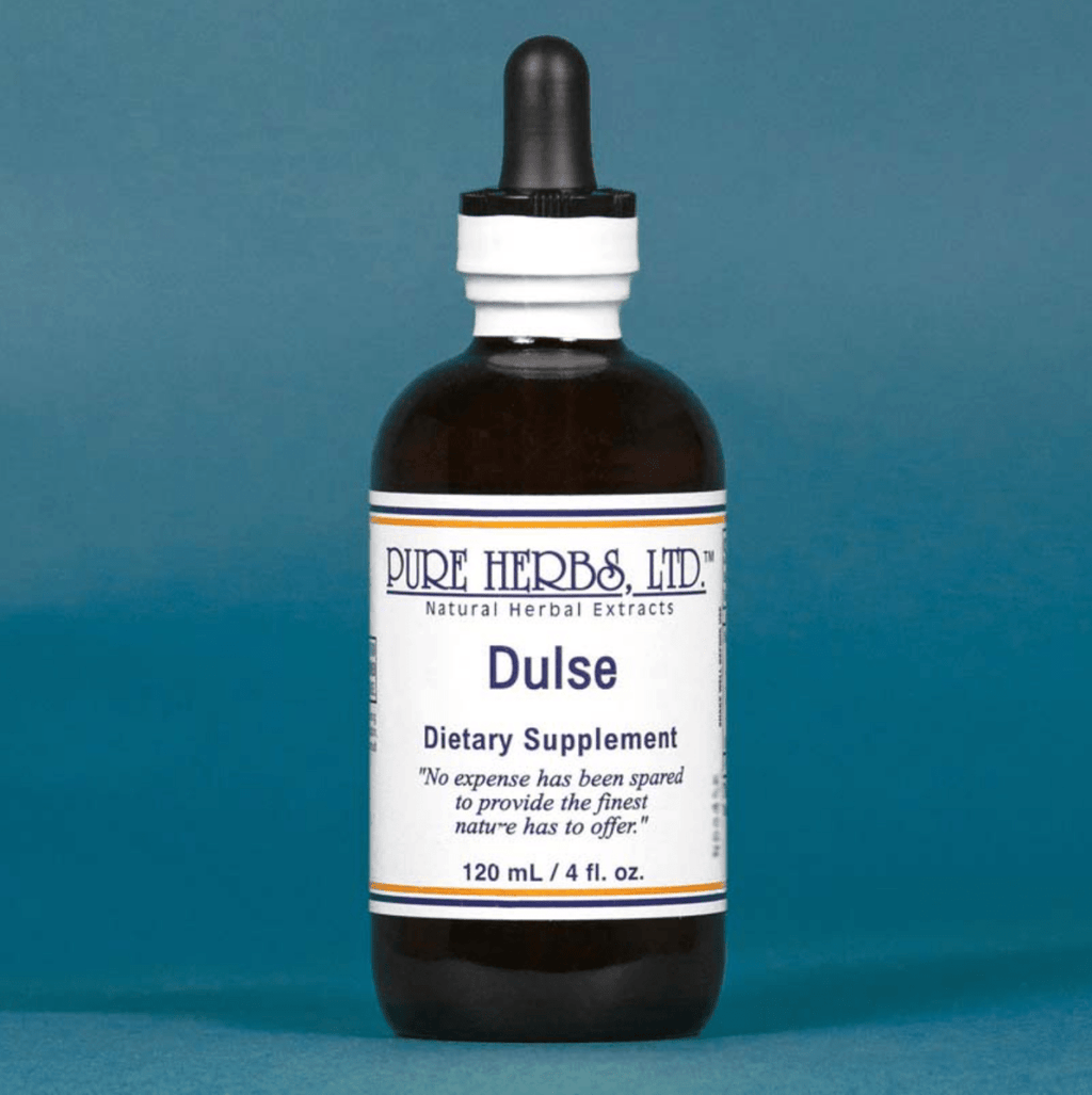 A 120 mL amber glass dropper bottle of Pure Herbs, Ltd. Dulse dietary supplement, featuring a white label with blue text and a black dropper cap, set against a solid slate blue background.