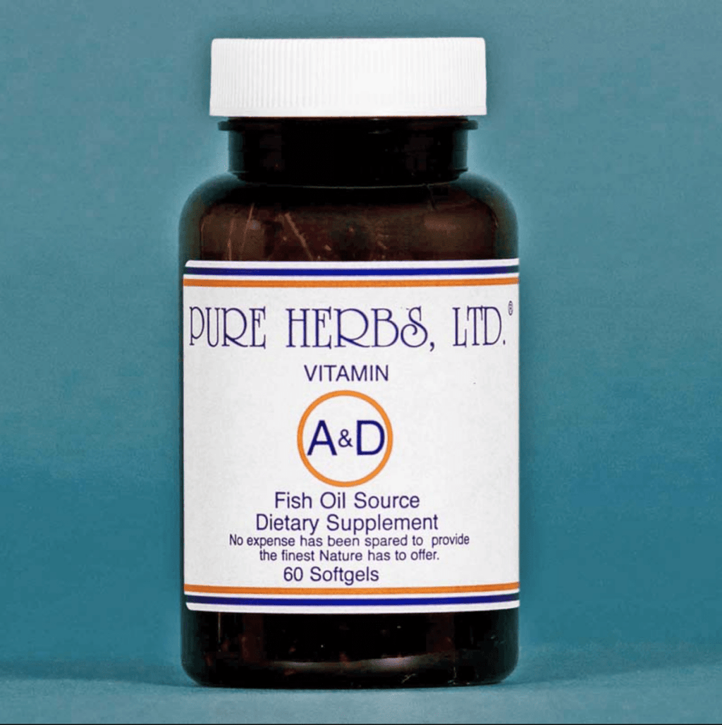 A dark amber bottle of Pure Herbs, Ltd. Vitamin A&D Fish Oil Source dietary supplement with a white label and white cap, set against a solid blue-gray background.